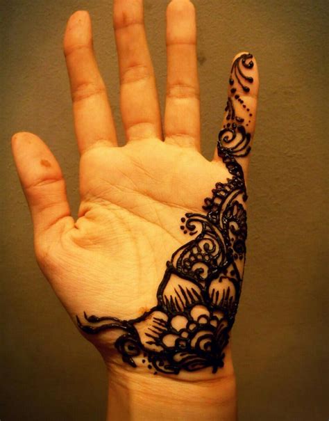 A Hand With A Black And White Henna Tattoo On It S Left Palm