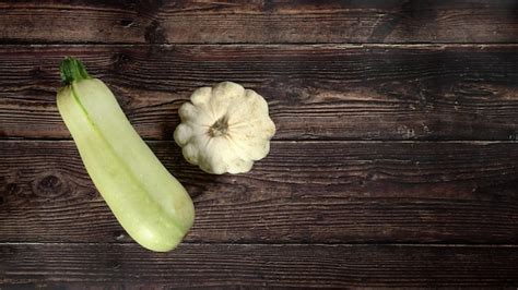 Premium Photo Light Green Zucchini And Pattypan Squash On Dark Wooden