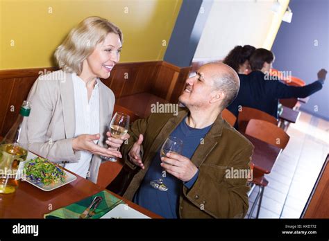 Ordinary Smiling Mature Couple Having Dinner At Restaurant Table Stock Photo Alamy