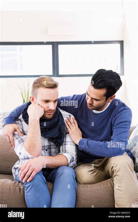Gay Couple Comforting Each Other On The Couch Stock Photo Alamy