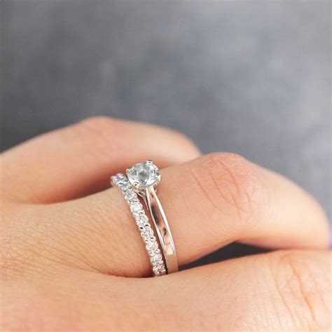 A Woman S Hand With A Diamond Ring On Top Of Her Finger And The Other