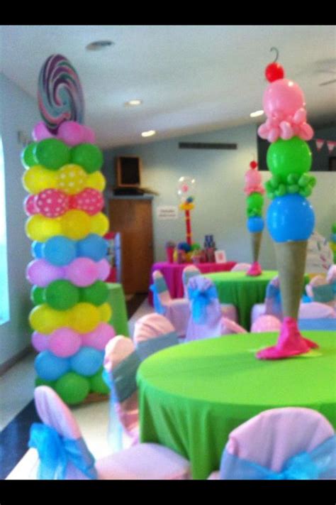 A Room Filled With Lots Of Colorful Balloons And Tables Covered In