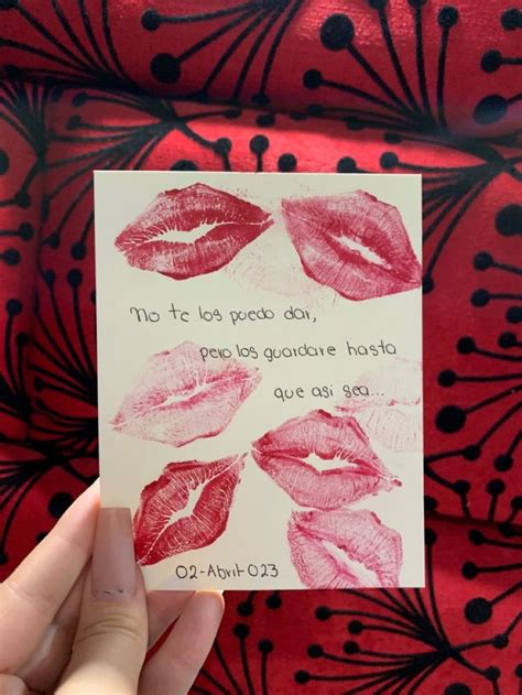 Someone Holding Up A Card With Lipstick On It