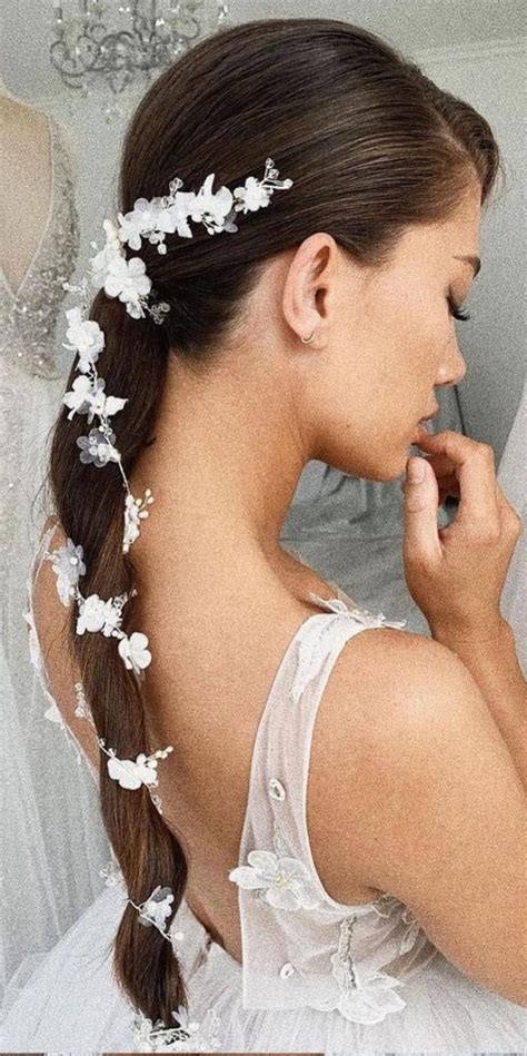 35 Enchanting Hairstyles For A Fairytale Wedding Ponytail With White