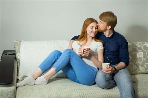 Premium Photo Beautiful Couple Man And Woman Sitting On The Sofa At Home