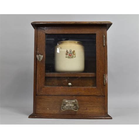 A Late Victorian Edwardian Oak Smokers Cabinet With Glazed Door To Fitted Interior And Inner Drawer