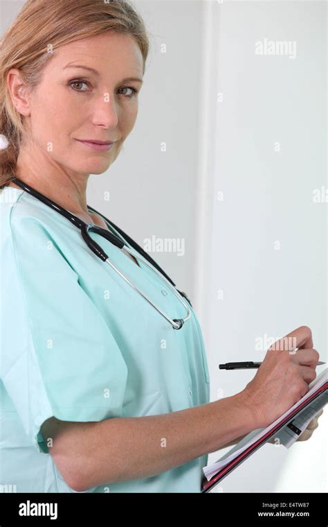 Female Nurse Holding Clipboard And Pen Stock Photo Alamy