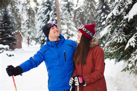 Premium Photo Happy Married Couple Skiing At A Ski Resort In The Forest