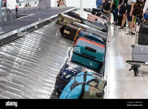 Baggage Luggage At Airport Arrival Carousel With Passengers Awiating To