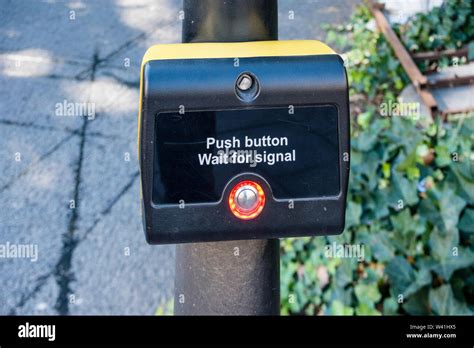 Push Button And Wait For Signal Device At Pedestrian Crossing In Street