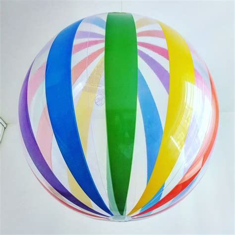 A Multicolored Hot Air Balloon Is Hanging From The Ceiling In Front Of