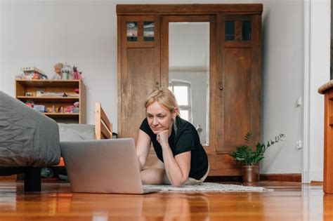 Premium Photo Mature Woman Using Laptop On Floor