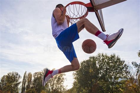 Young Basketball Street Player Making Slam Dunk Stock Photo Image Of