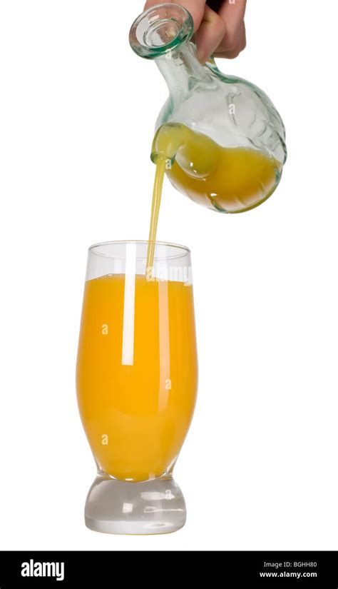 Man Is Pouring Orange Juice Into Glass Stock Photo Alamy