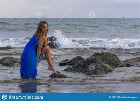 Lovely Brunette Latin Model Poses Outdoors On A Beach At Sunset Stock