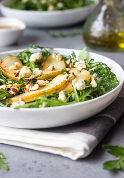 Premium Photo Arugula Gorgonzola Cheese Caramelized Pear And Nut Salad