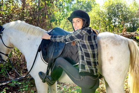 Cavaleiro Da Jovem Mulher Que Monta Um Cavalo Branco Imagem De Stock