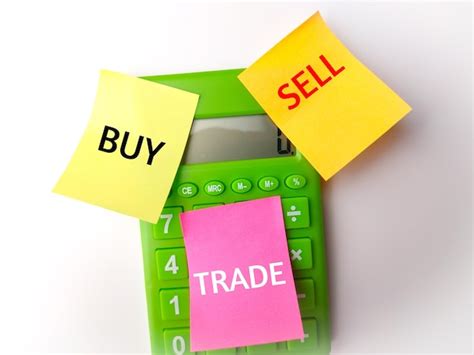 Premium Photo Calculator And Sticky Note With The Word Buy Sell Trade