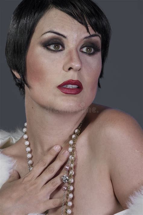 1920s Style Brunette Dancer With Short Hair And Jewelry She Is Stock