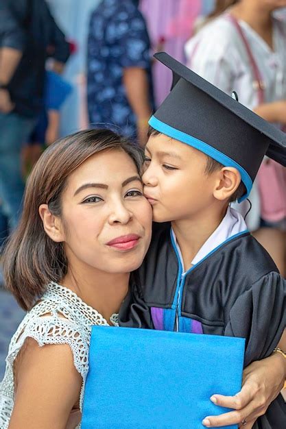 Premium Photo Portrait Of Smiling Mother Being Kissed By Son In