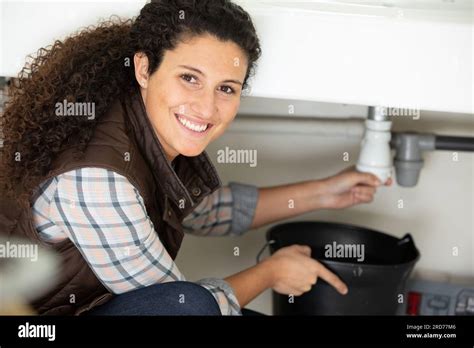 Happy Female Plumber Fixing Sink Stock Photo Alamy