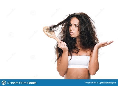 Brunette Woman Looking At Wavy Unruly Hair In Comb Isolated On White