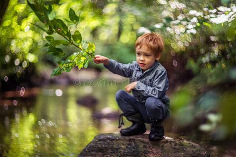 Cute Kid Boy Near Water Splashing Caucasian White Toddler Playing In