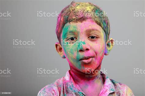 Portrait Of Boy With Face Smeared With Colored Powder Stock Photo