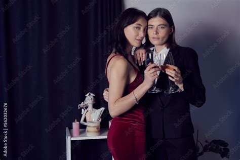 Cropped Close Up Shot Of A Two Lesbian Girls With Glasses Of White Wine