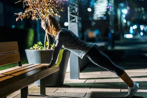 Premium Photo Woman Exercising In City At Night