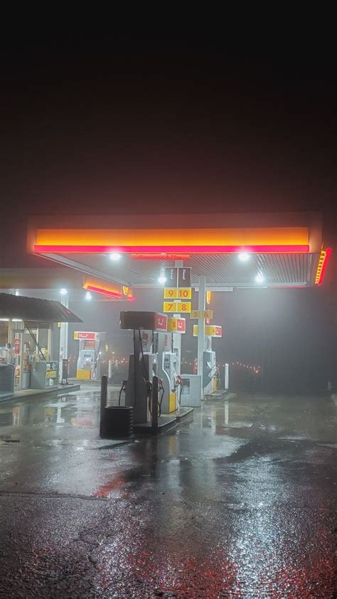 A Gas Station At Night With The Lights On