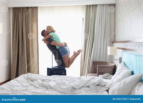 Man Picking Up Woman In Hotel Room With Suitcase Stock Image Image Of