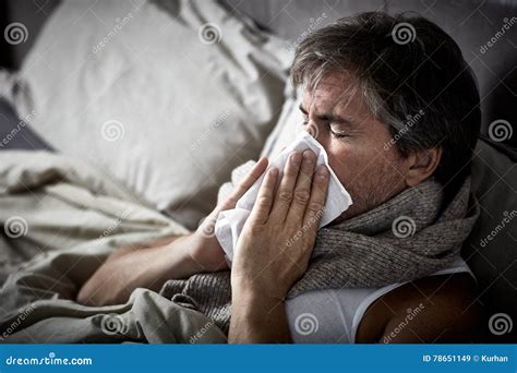 Sick Man With Cold Lying In Bed And Blow Nose Royalty Free Stock