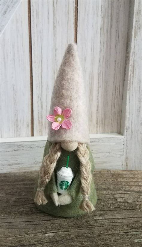 This Mini Girl Gnome In Olive Green With A Cream Hat That Has A Pink