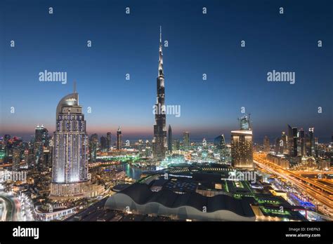 Burj Khalifa , the Dubai Mall and skyline of Downtown Dubai at night in ...