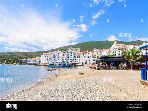 Picturesque beach and waterfront whitewashed buildings of Cadaques Town ...