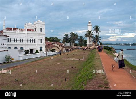 Galle Fort Lighthouse And Mosque Early Evening With Street Hawkers On