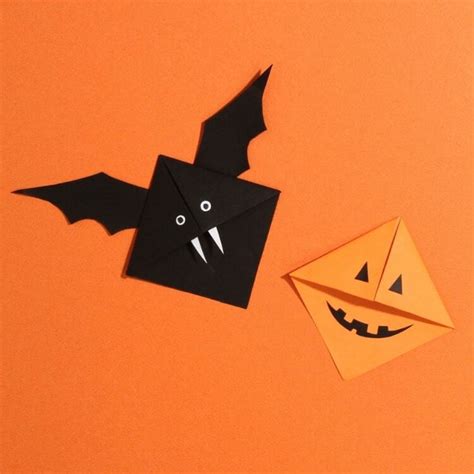 An Origami Bat And A Paper Pumpkin On An Orange Background With The