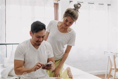 Funny Couple Wife Peeking Husband Who Chatting On The Smartphone