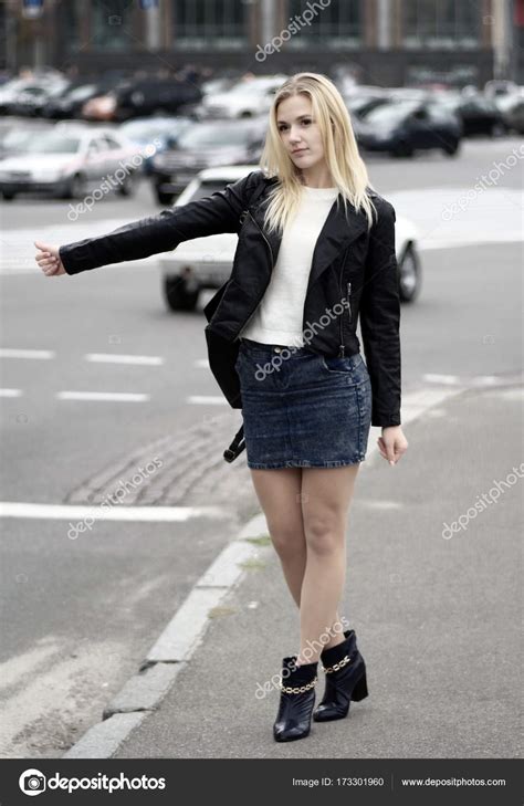 A Pretty Looking Blonde Woman Tries To Pick Up A Car On The Road Stock Photo By Atdigit 173301960