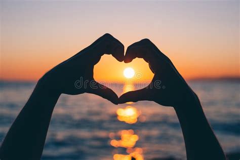 Male Hands in the Shape of a Heart at Sunset Stock Image - Image of ...