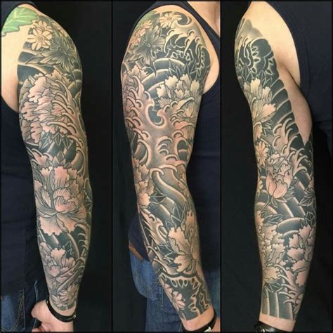 Black And Grey Dragon Sleeve Tattoo