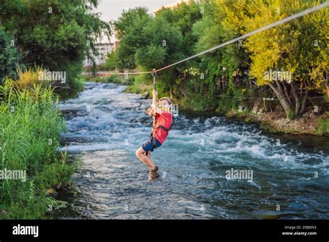 Kid Zipline Zipline Over The River Kid Adventure Stock Photo Alamy