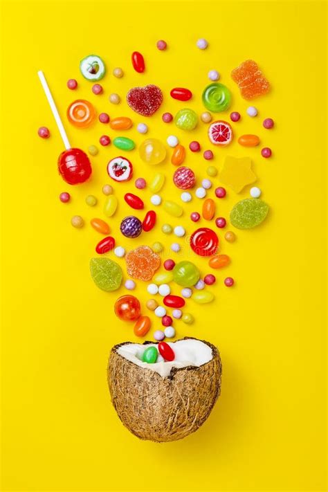 Colorful Explosion Of Candies In Coconut On Yellow Colored Background