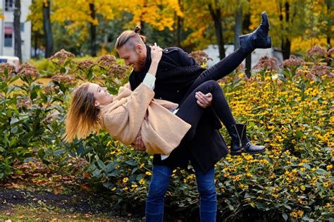 Free Photo Redhead Bearded Male Holds In His Arms Cute Blonde Female