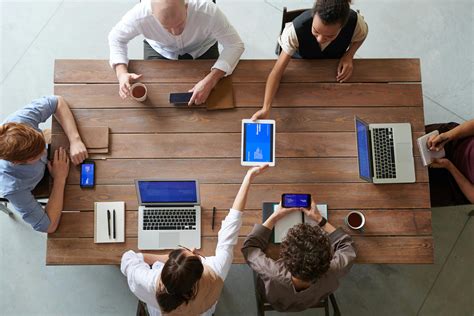 Group Of People Seated Around Table Discussing · Free Stock Photo