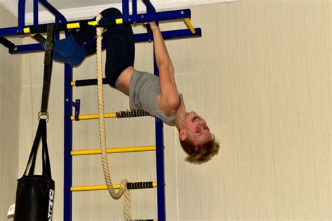 The Boy Hung Upside Down On The Horizontal Bar Stock Photo Image Of