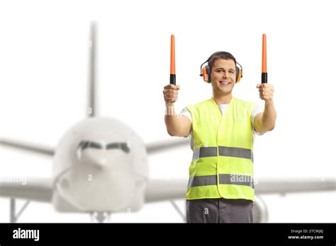 Aircraft Marshaller Signaling With Wands In Front Of An Aircraft Stock