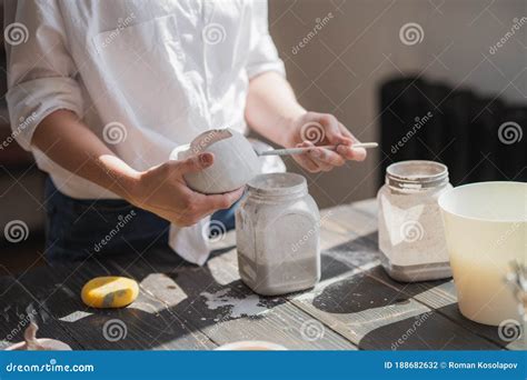 Female Potter Glazing Raw Unburned Ceramic Cup Using Brush Earthenware