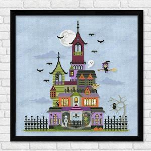 A Cross Stitch Halloween House With Bats And Pumpkins